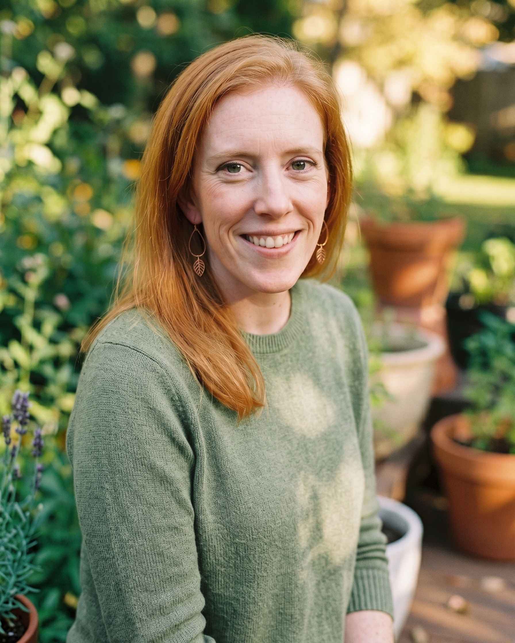 Holly O'Brien of Lady Hao outdoors among greenery, softly lit