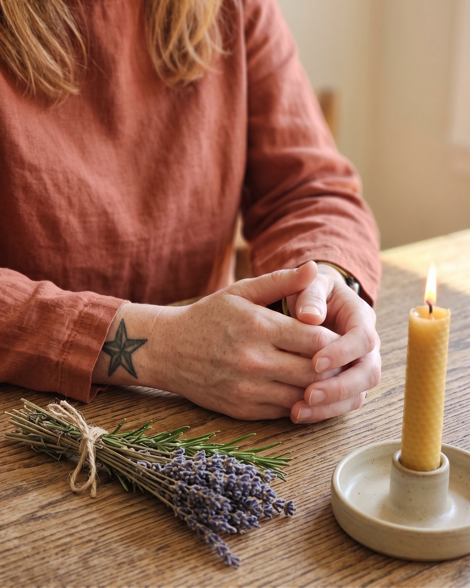 Close-up of Holly's hands holding tarot cards during a healing session